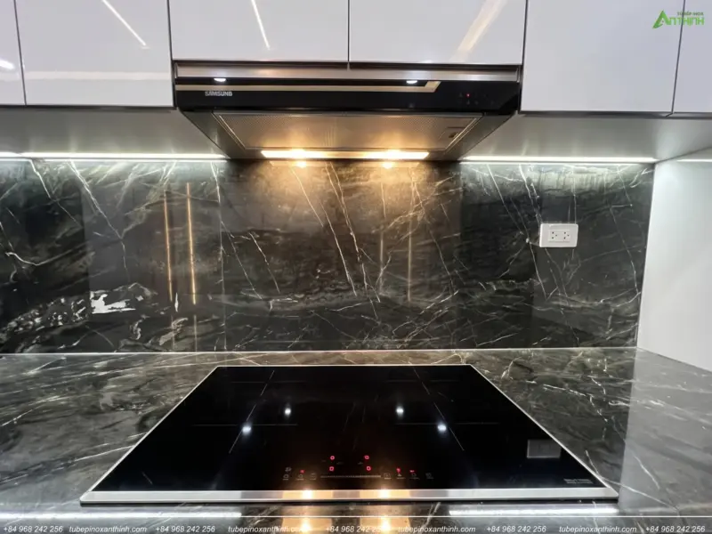 Chi tiết bếp từ và kính ốp đá tủ bếp Acrylic bóng gương nhà anh Dương tại Gia Lâm, Hà Nội